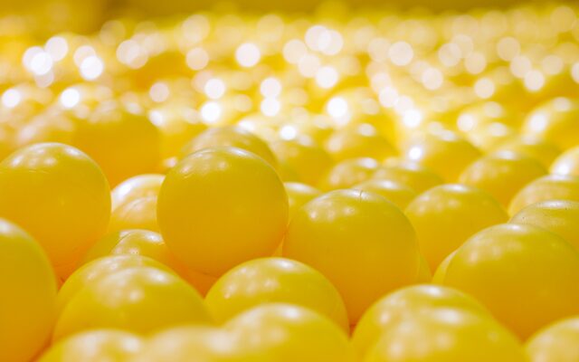 Close-up of yellow balls densely packed together.